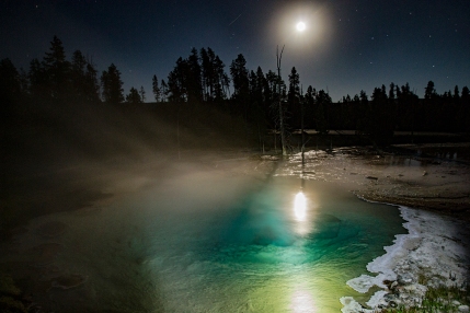 Full moon reflecting off a prismatic pool at Geyser Basin in Yellowstone National Park